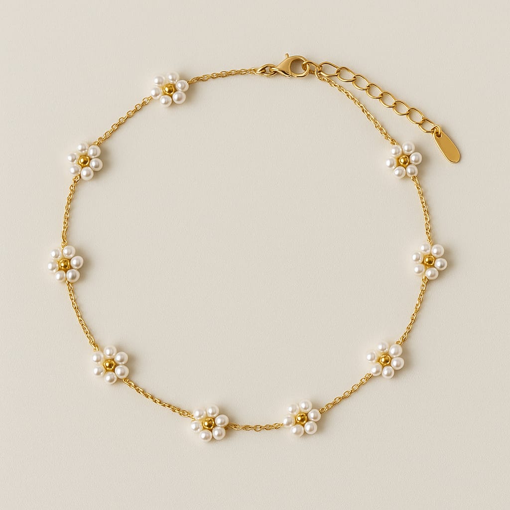 Gold bracelet with pearl flower charms on a beige background